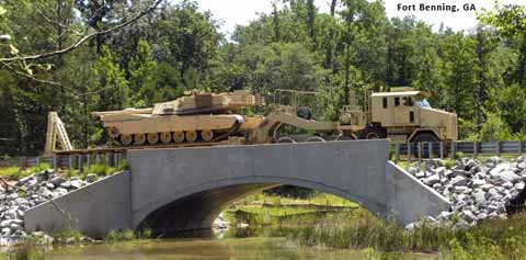 Military machinery crosses bridge on Fort Benning