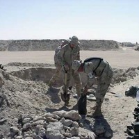 Soldiers filling sandbags at Camp Doha